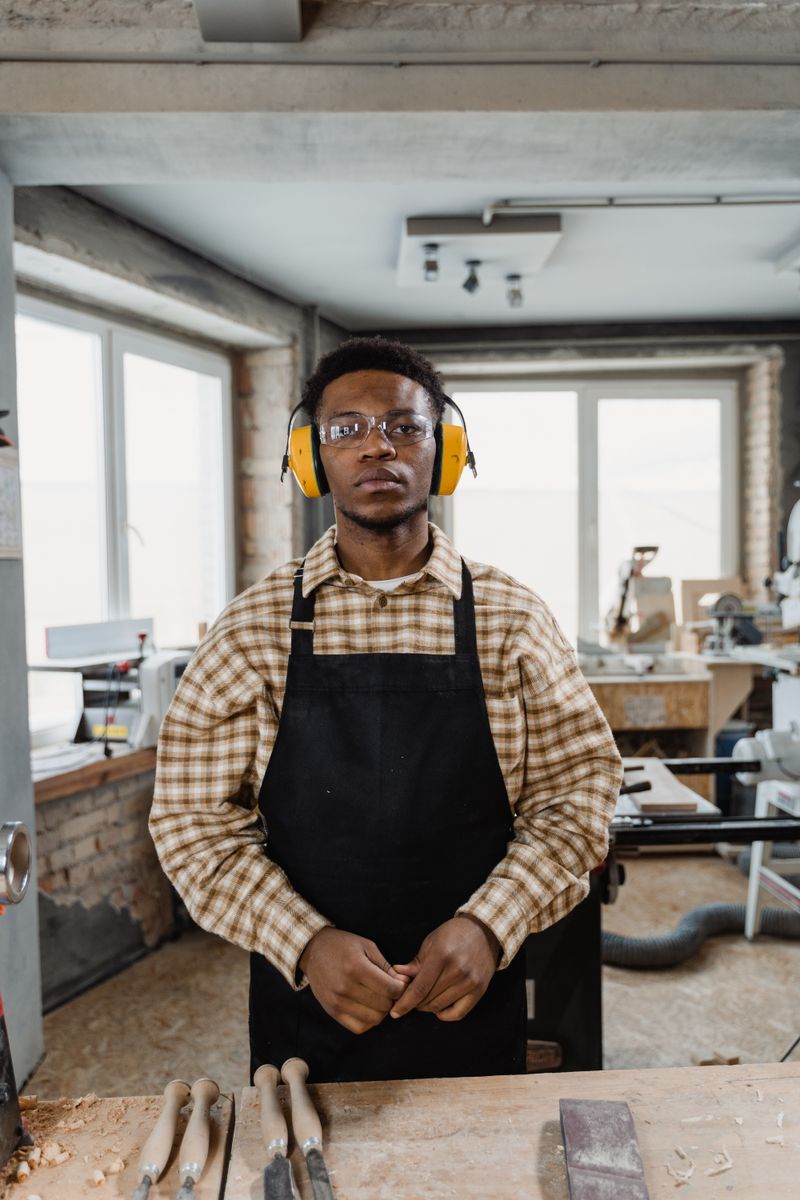 Chinedu at work on a wooden project in the workshop