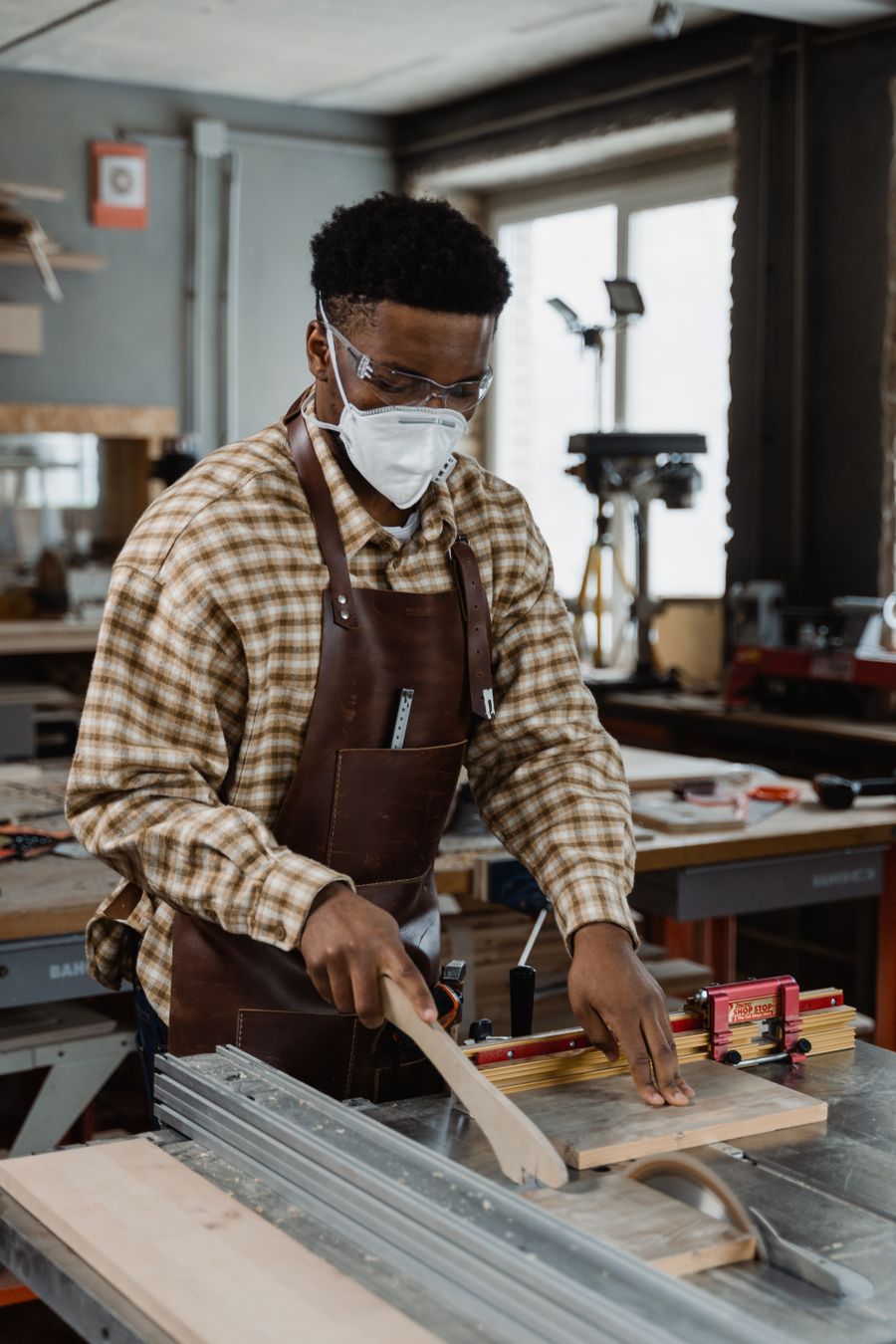 A craftsman working with wood in a well-equipped workshop