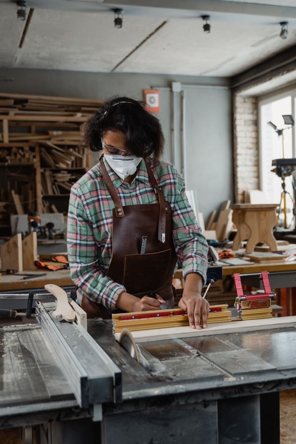 Artisan working on wood in a woodworking workshop