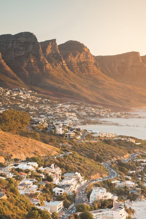 Free A breathtaking aerial view of Cape Town's stunning coastline and mountains at sunset. Stock Photo