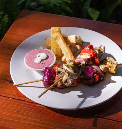 A Plate of Mixed Vegetables on Barbeque Sticks