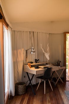 Stylish home office featuring a wooden desk and modern lamp, perfect for productivity.