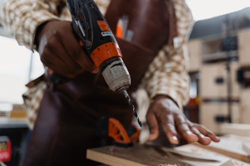 Free A Man Holding an Electric Drill Stock Photo