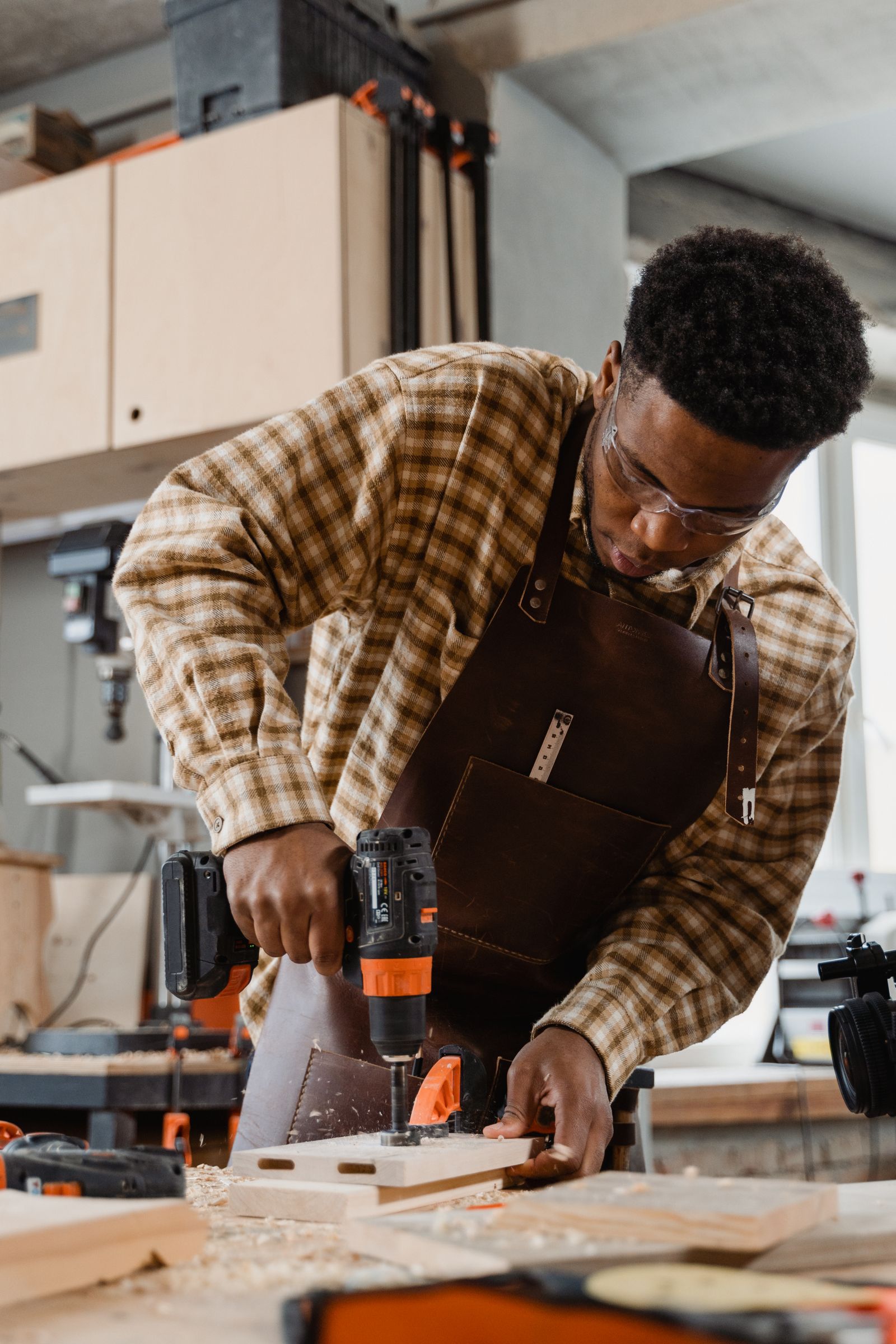 Craftsman working with power tools in a professional workshop