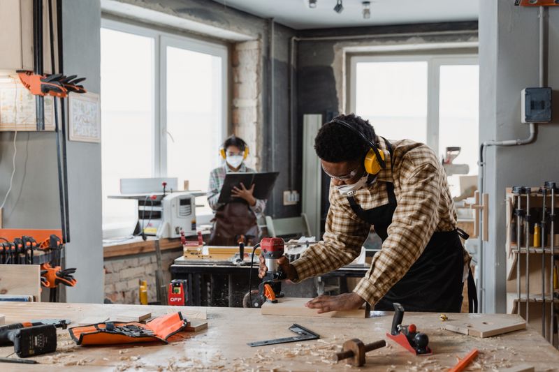 Craftsman at work among timber stacks