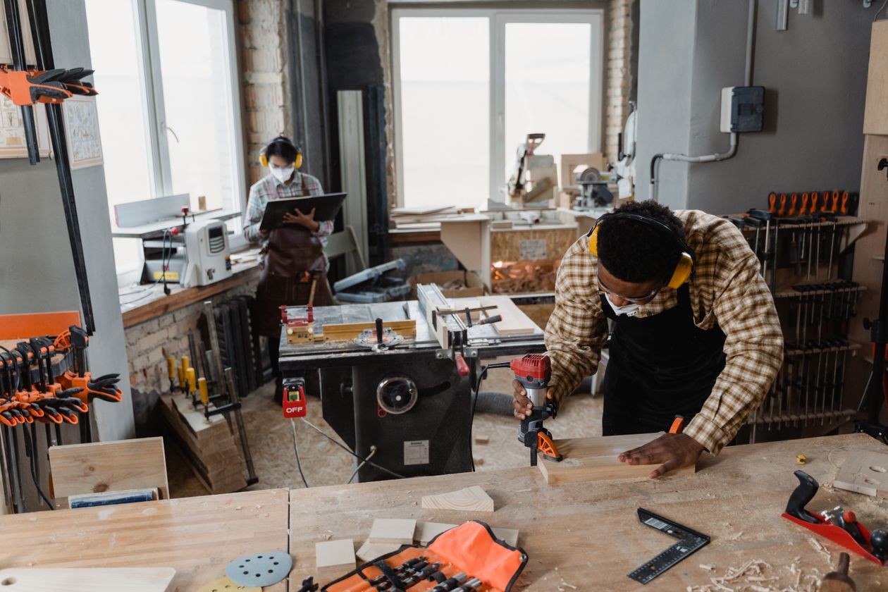 Two artisans at work in a well-equipped woodshop