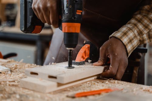 Free Carpenter Drilling a Wood Stock Photo