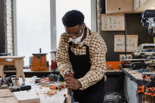 Free An African American craftsman focuses on woodworking in a well-equipped workshop. Stock Photo