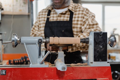 A Man Using a Wood Lathe