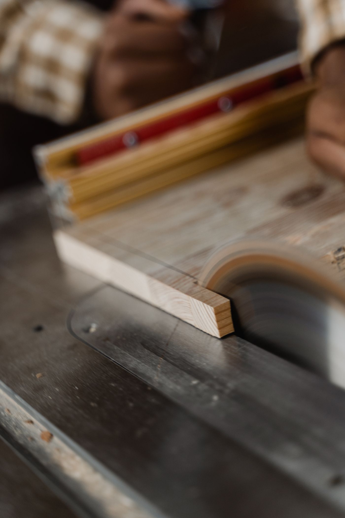 Craftsman cutting wood with a circular saw in a workshop
