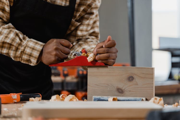 A Person Using A Wood Planer