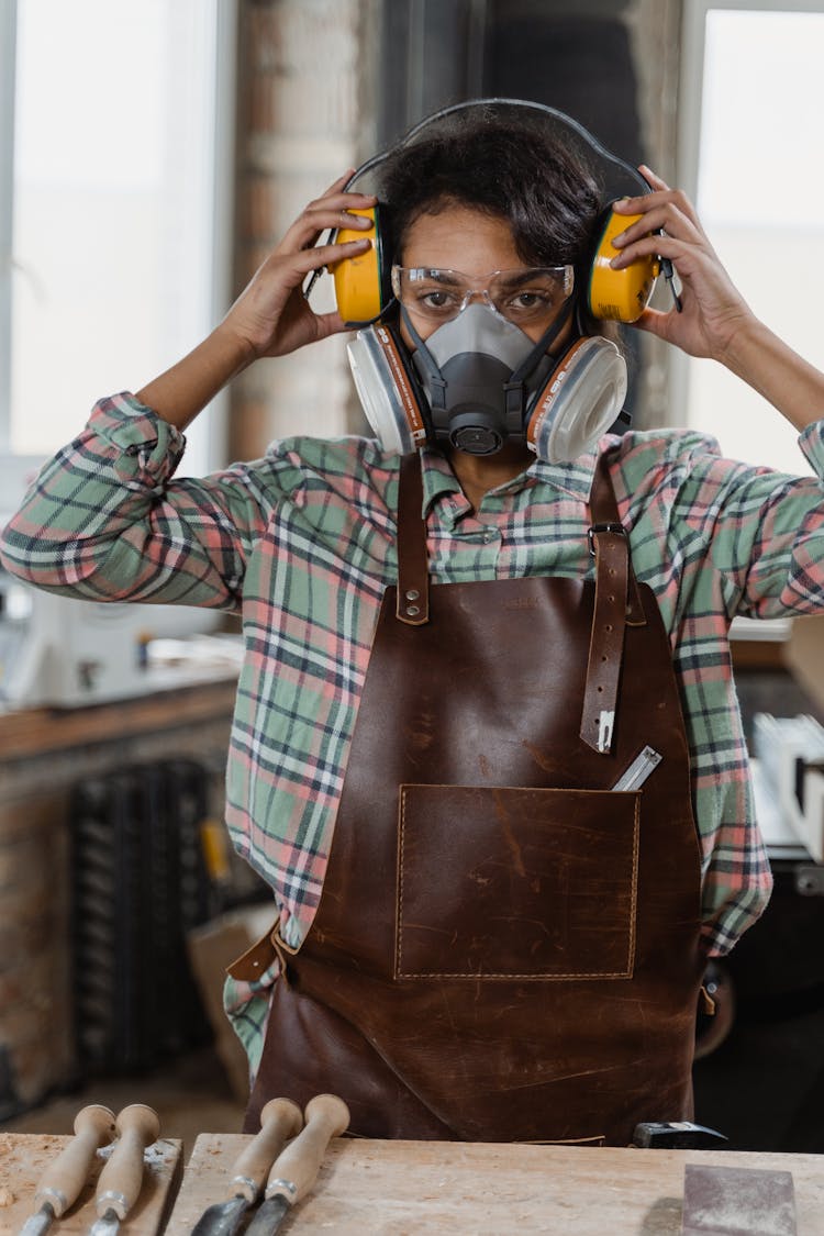 Person With Gas Mask And Protective Goggles Wearing Headset