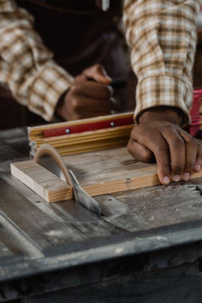Table saw cutting a piece of wood in a workshop