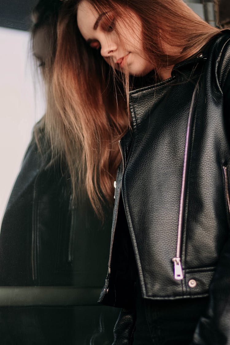 Young Woman In Leather Jacket Posing