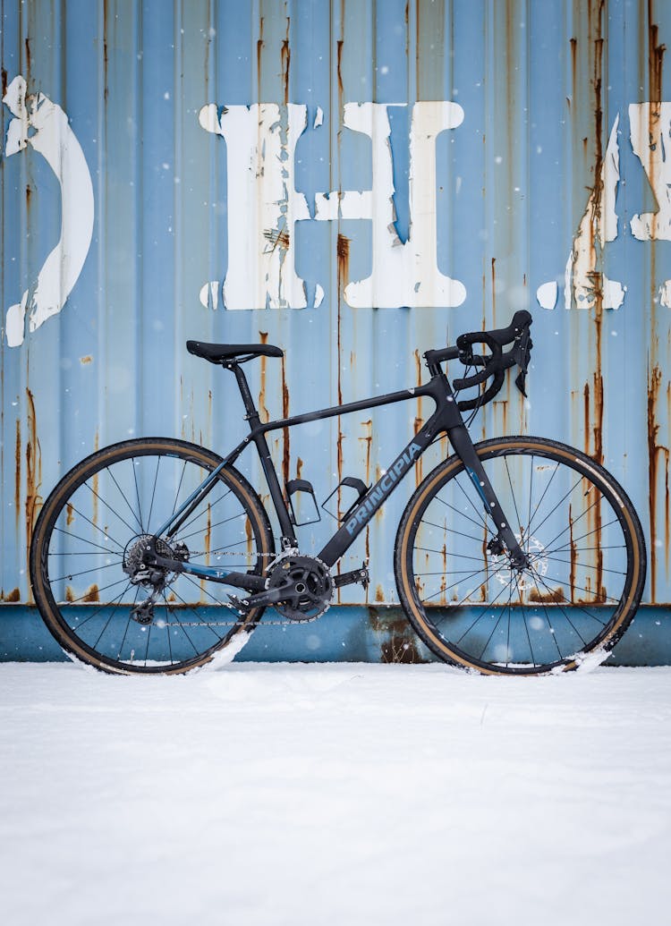 Racing Bike Beside The Cargo Container On The Snow Covered Ground