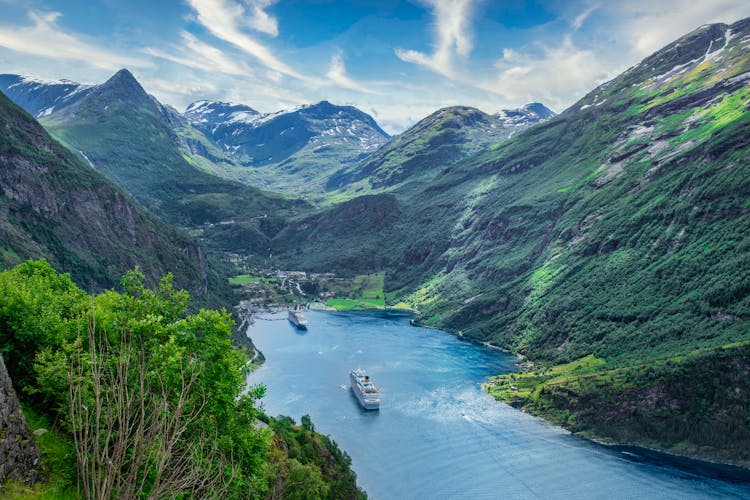 Cruise Ships On The Lake Surrounded By Mountains 