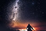 Silhouette of a Person Under the Starry Sky