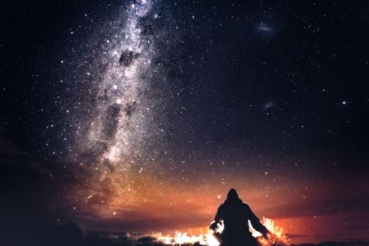 Witness the stunning Milky Way with a silhouetted figure beneath New Zealand's starry night sky.