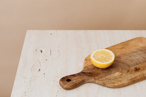 Free Sliced Lemon on a Wooden Chopping Board Stock Photo