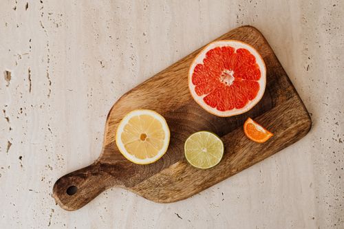Free Top view of sliced citrus fruits on a rustic wooden board. Stock Photo