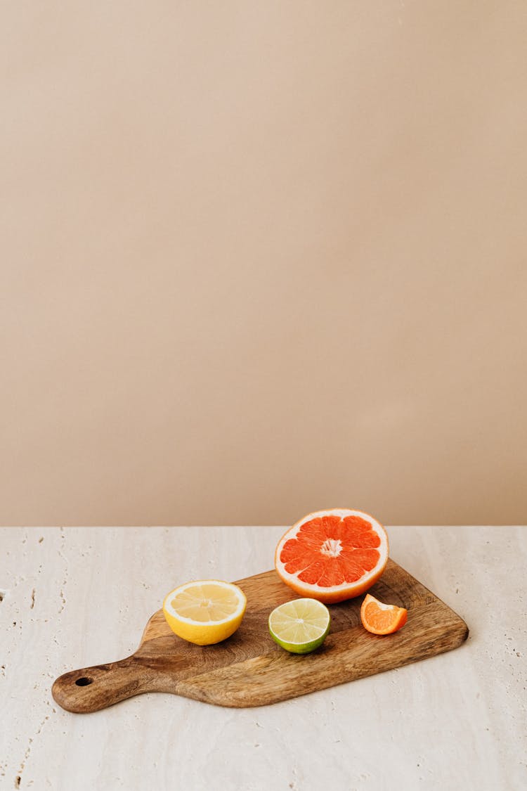 Pieces Of Citrus Fruits On Cutting Board