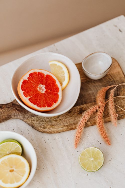 Free Sliced grapefruit and lemon on a wooden board, offering a cozy home vibe. Stock Photo