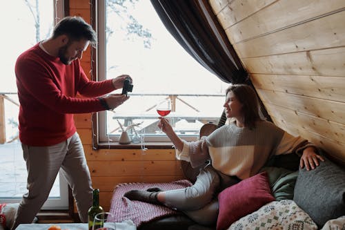 Free Man Photographing Woman with Wine Stock Photo