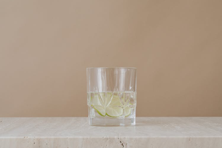 Clear Drinking Glass With Water And Lime