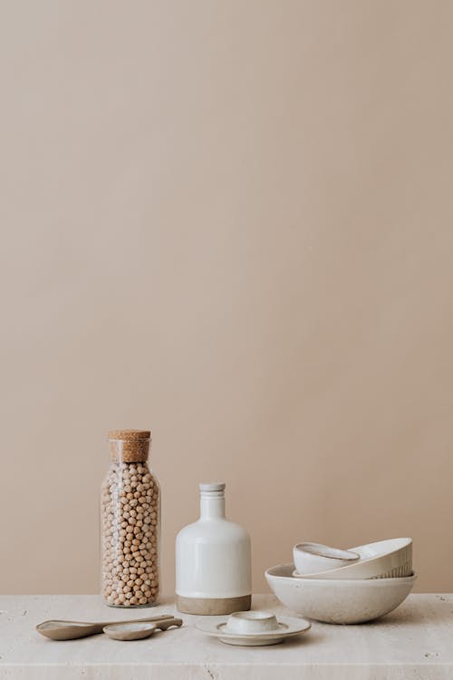 Ceramic Items and Glass Bottle On Marble Top