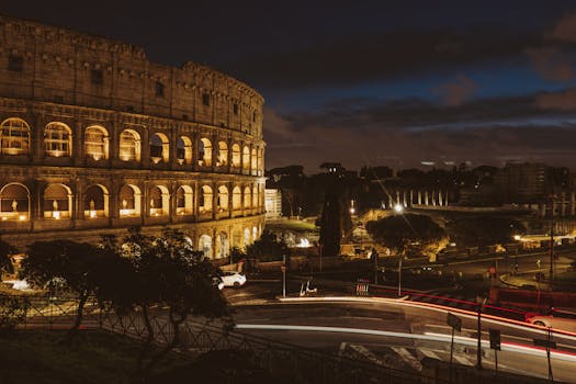 Stunning nighttime view of the illuminated Colosseum in Rome, capturing its historical grandeur.