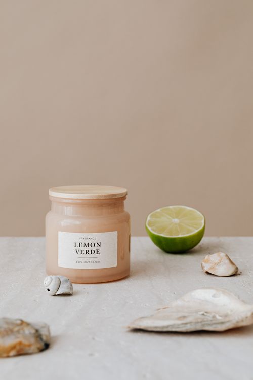 Free Aesthetic candle with lime and seashells, perfect for modern home decor. Stock Photo