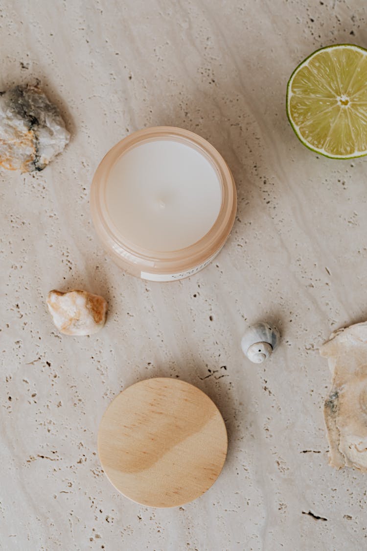 Top View Of A Candle In A Jar, Seashells And Lime 