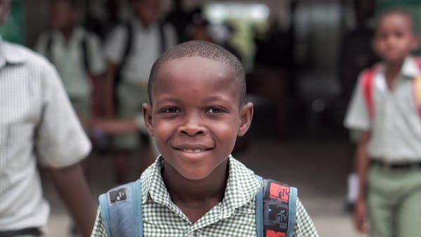Boy with backpack smiling