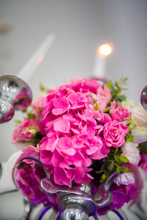 Bouquet with Hydrangea flowers and roses against candlestick