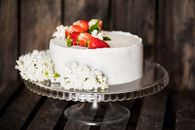 Delicious cake with berries on table