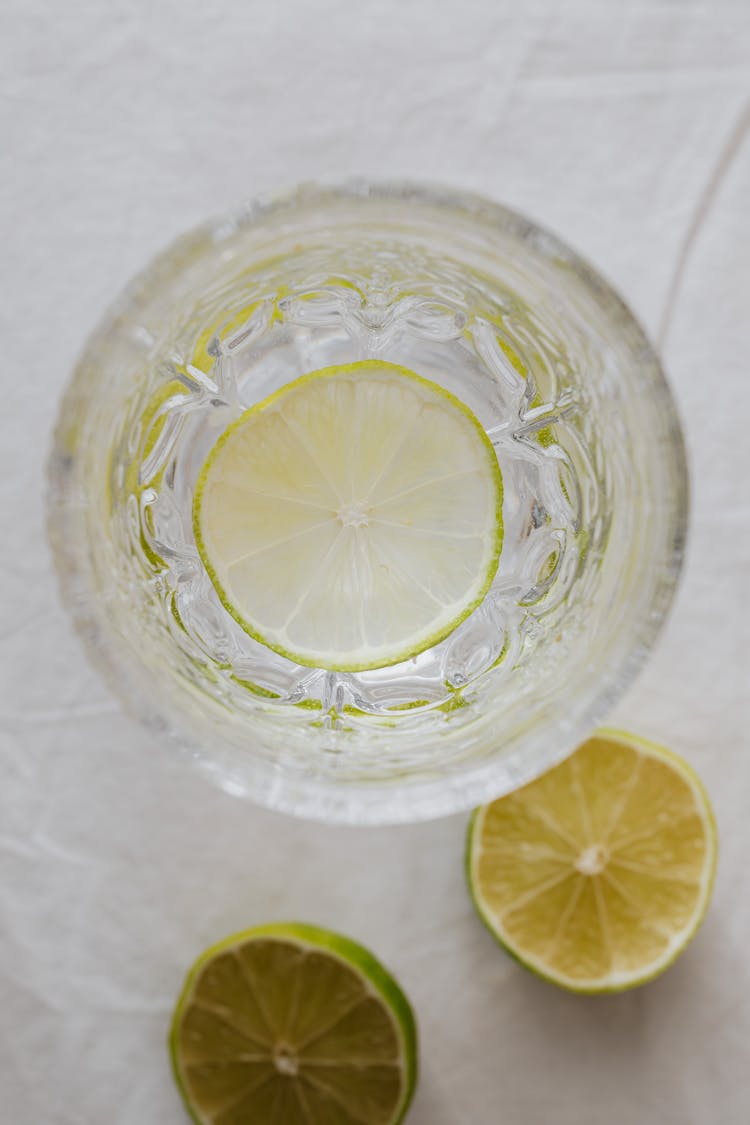 A Close-Up Shot Of A Sliced Lime On A Glass