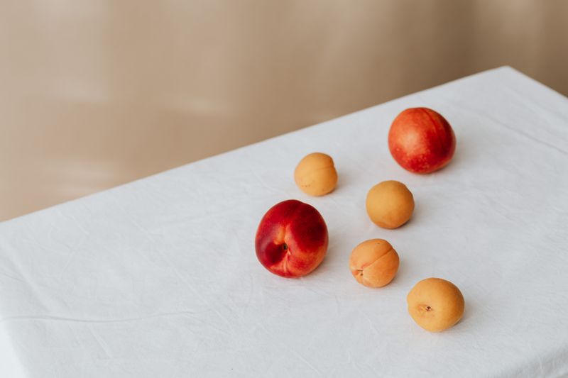 Nectarines and apricots on white linen