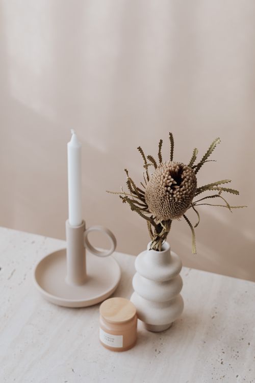 Free Aesthetic minimalist setup with vase and candle on a neutral table, ideal for decor inspiration. Stock Photo