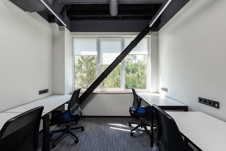 Modern Office Interior With Tables Near Chairs