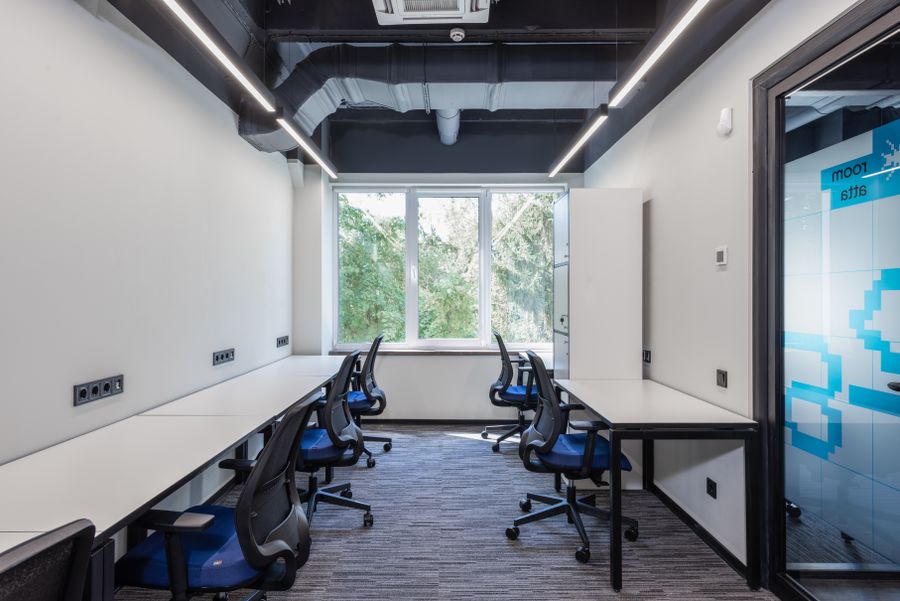 Modern office with glass doors and meeting space
