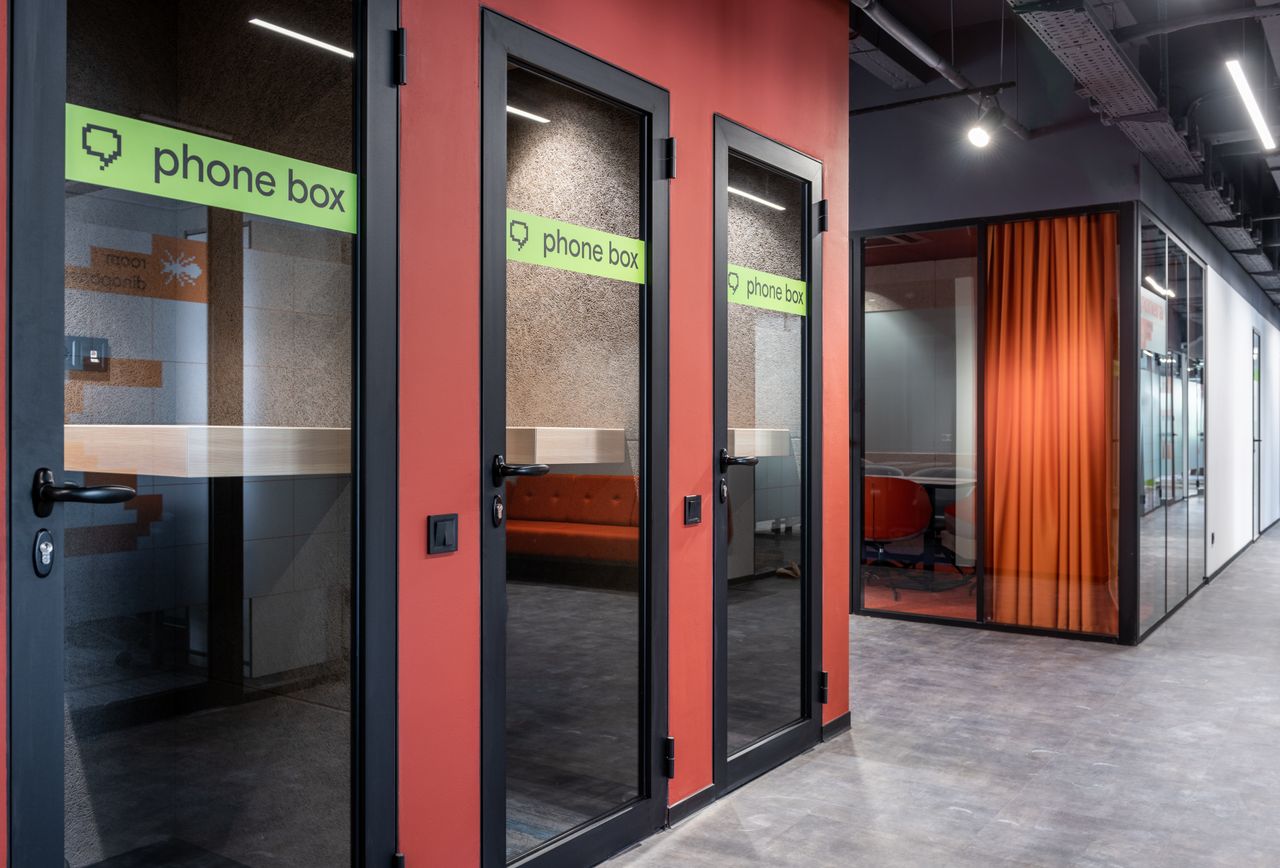 phone boxes with inscription on glass doors and conference room with r