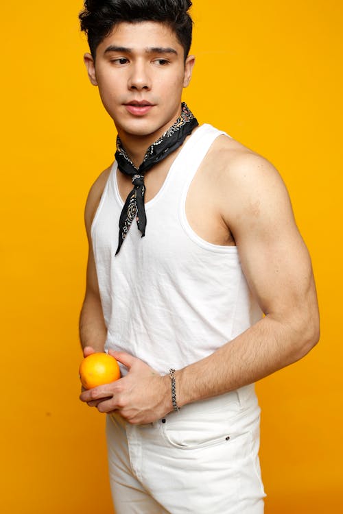 Безкоштовне стокове фото на тему «азіатський чоловік, апельсин, біла безрукавка»