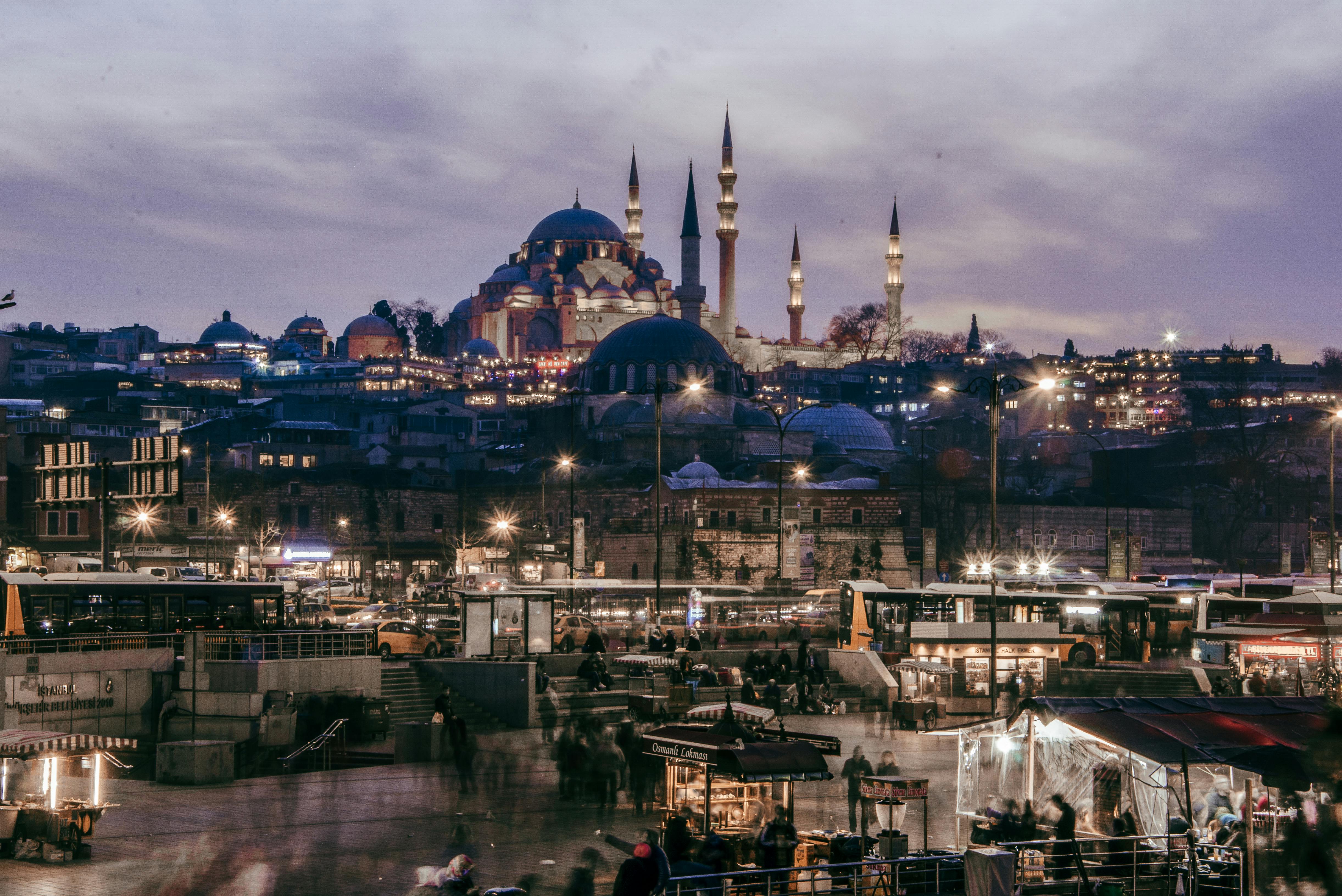 Free Illuminated night scene of Istanbul featuring the iconic S&uuml;leymaniye Mosque and bustling city life. Stock Photo