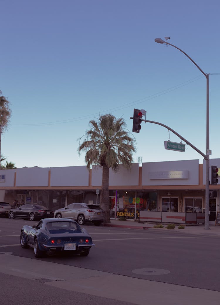 Cars Parked In Front Of Building Near Stoplight