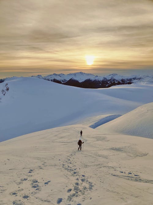 Aerial View of People Hiking in Snowy Mountains 