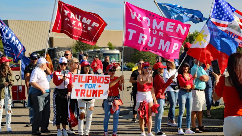 A group of diverse supporters at a political rally in Michigan.