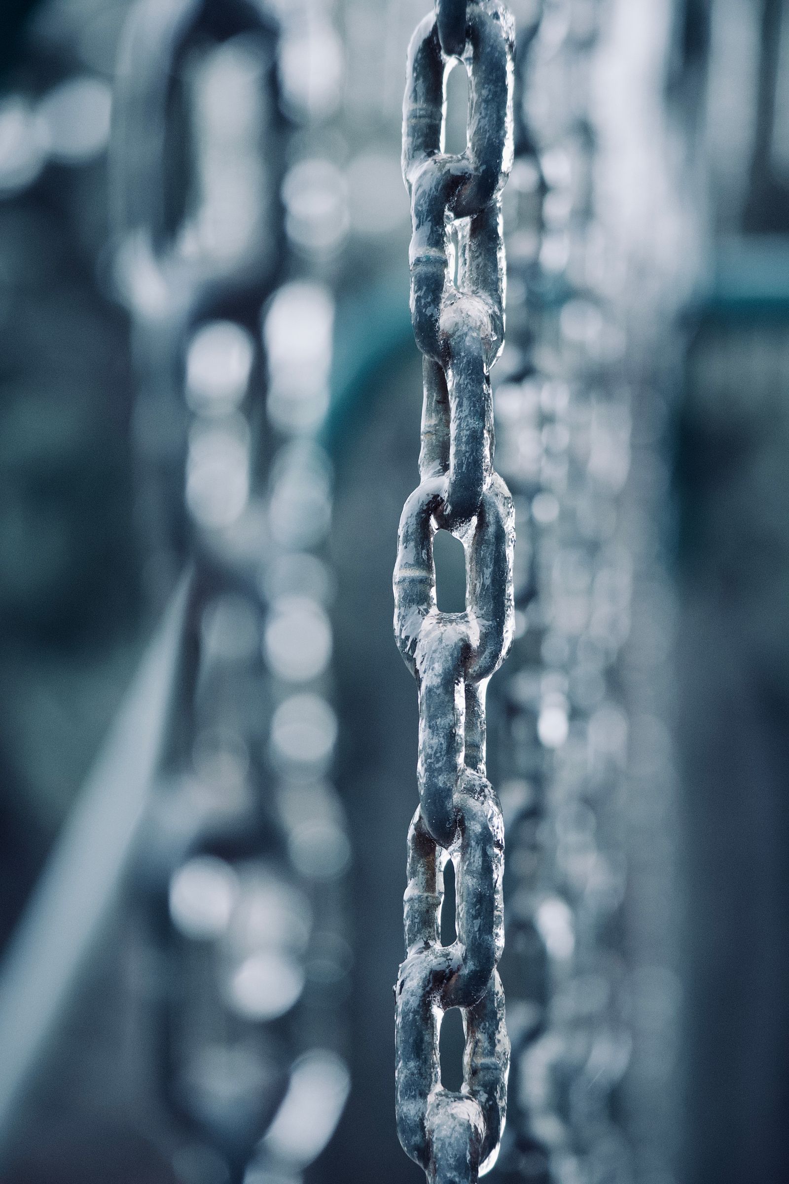 Textured close-up of weathered gray metal chain links