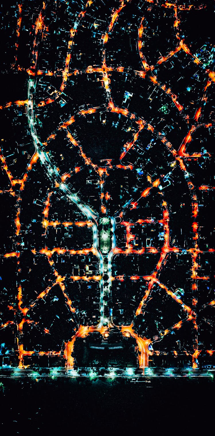 Drone Shot Of Illuminated City Streets At Night 