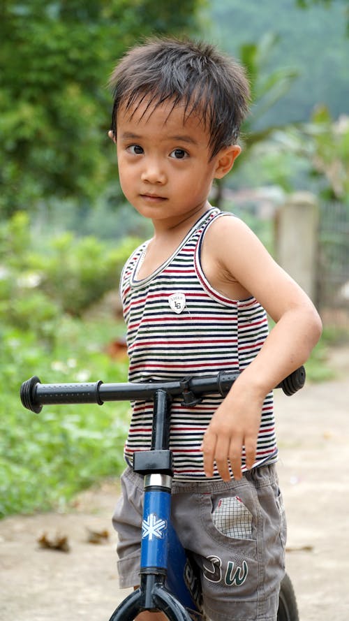 Portrait of a Little Boy on a Bicycle 