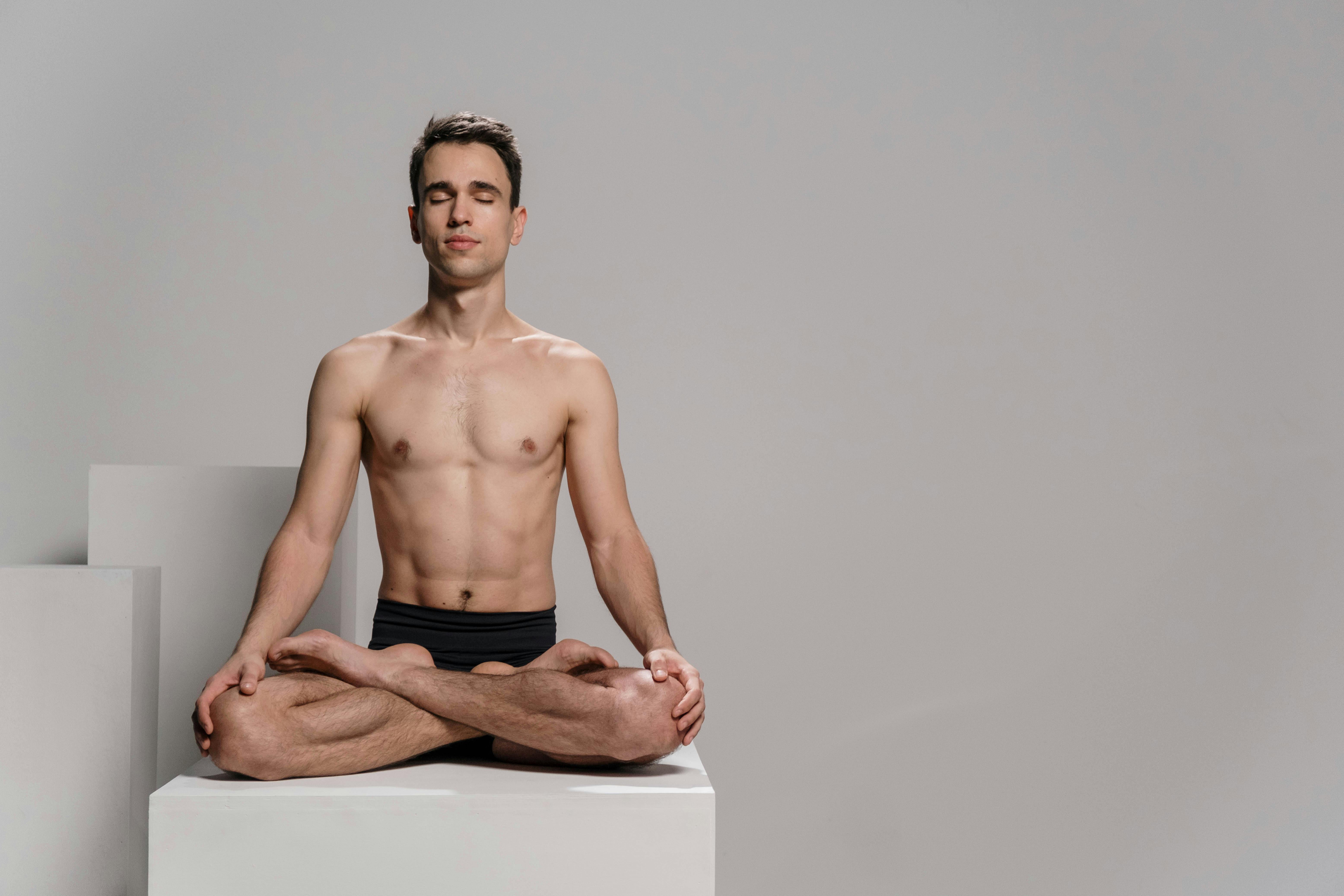 Man practice yoga. Young attractive male doing breathing exercises. Guy  meditating at home along during the pandemic. Relaxation and resting  concept Stock Photo - Alamy